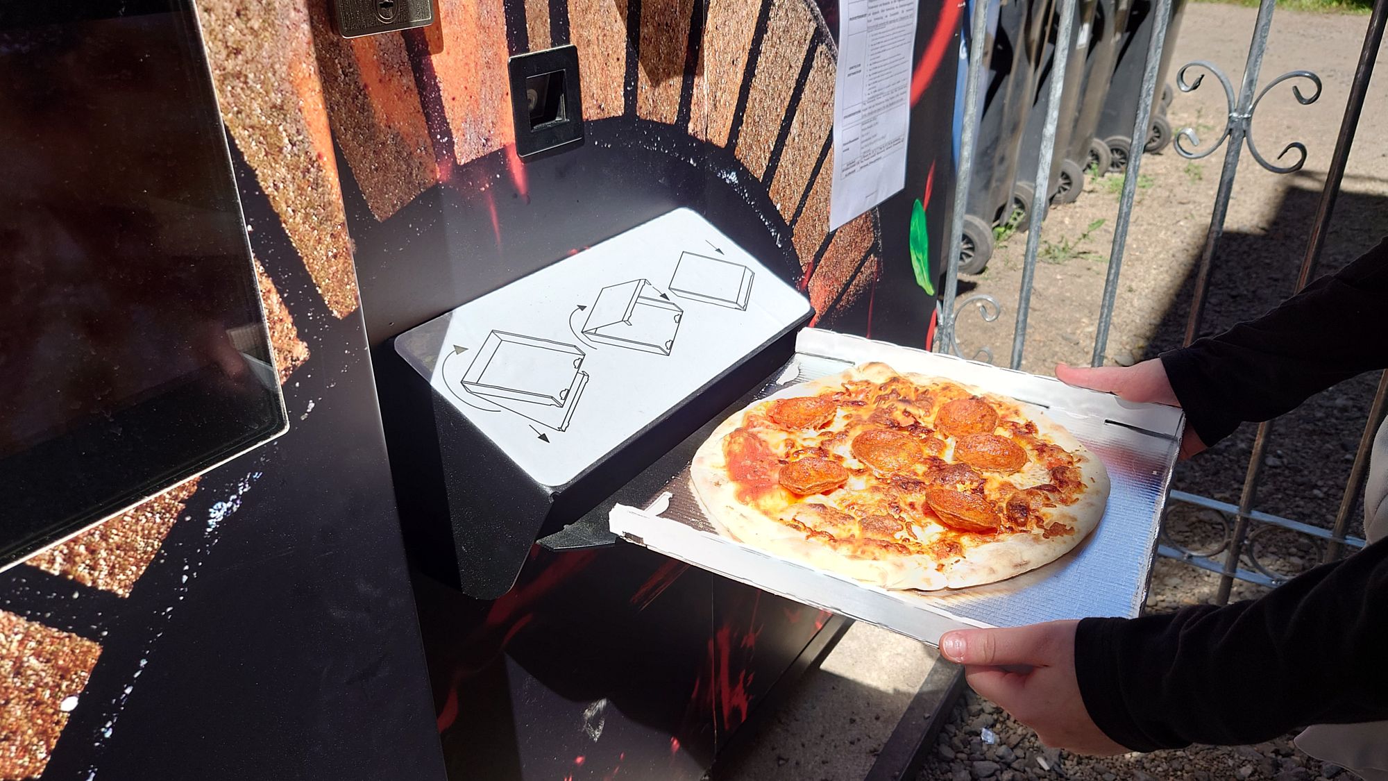 Automaten-Pizza: Schmeckt das? Beim Herausnehmen der Pizza, Foto: Anton Launer