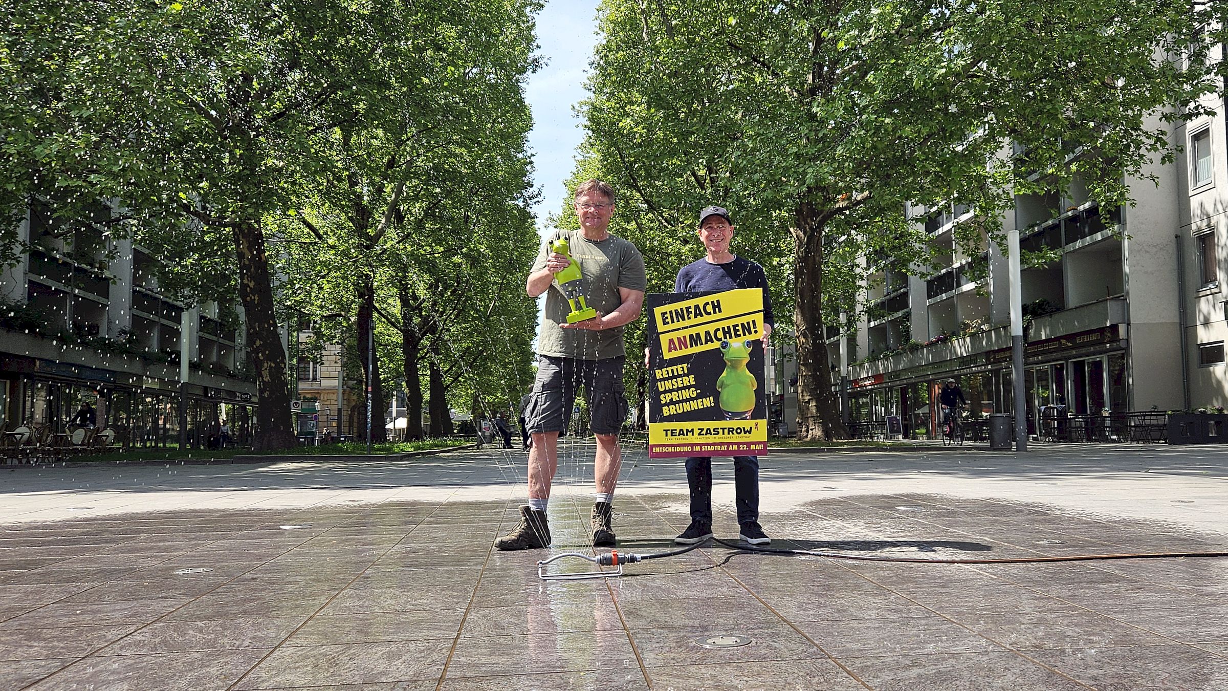 Zastrow improvisiert mit Gartenschlauch, Linke wird poetisch Einfach (an)machen - Holger Zastrow stellte einen Sprenkler auf den Jorge-Gomondai-Platz - Foto: Anton Launer